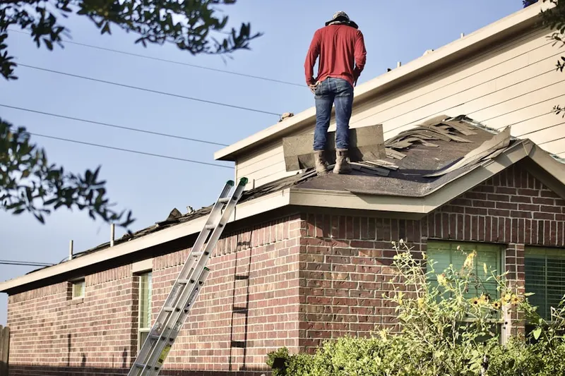 Professional roofer working on a residential roof in New Site